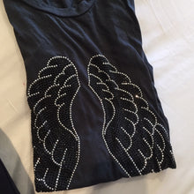 Load image into Gallery viewer, Photo of silver and black angel wings on a grey tank. 