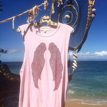 Load image into Gallery viewer, Pink tank top with red wings handing over the beaches in Mexico. 