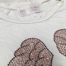 Load image into Gallery viewer, Image of the white tank with rose gold wings. 